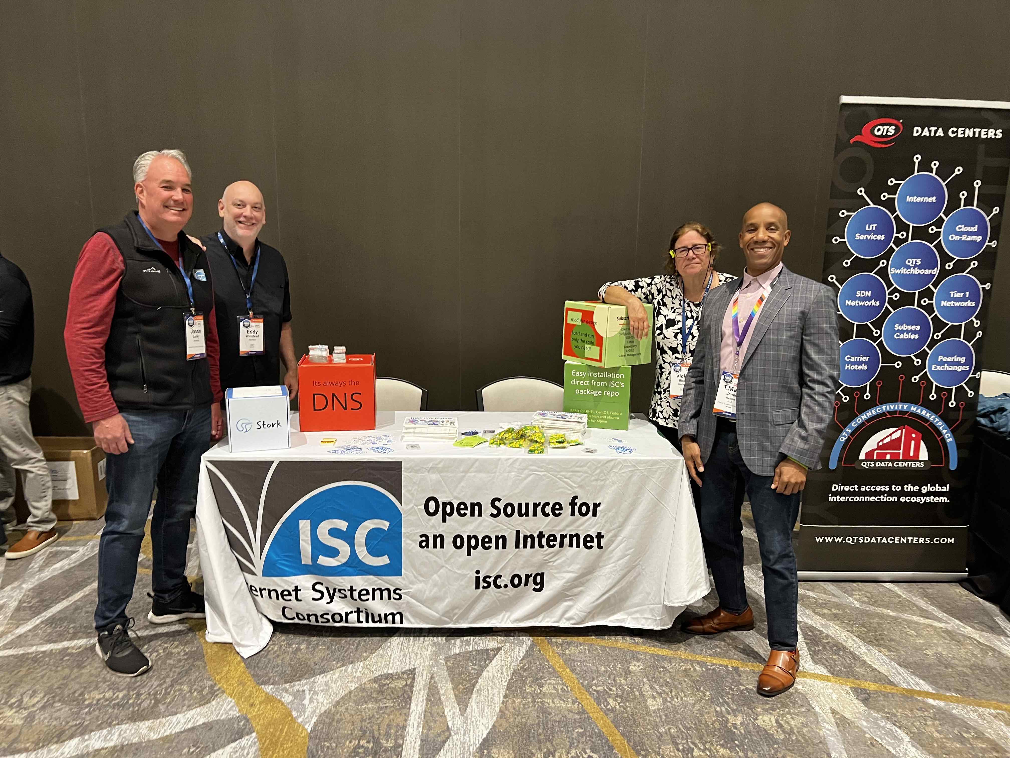 table with four smiling ISC staff
